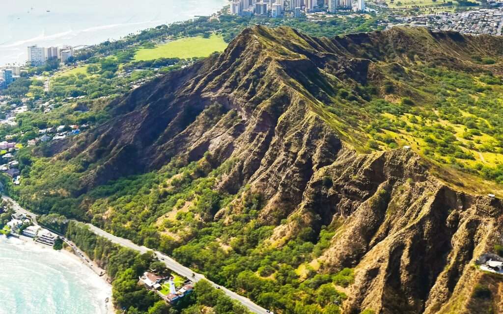 Aerial view of the Diamond Head crater rim above the coast road