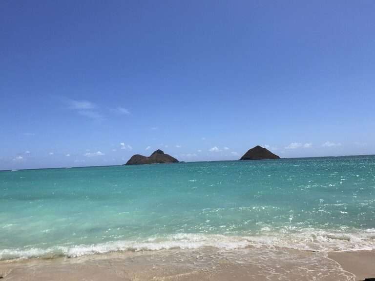 Turquoise water and the twin Mokulua islets offshore from the sand at Lanikai Beach